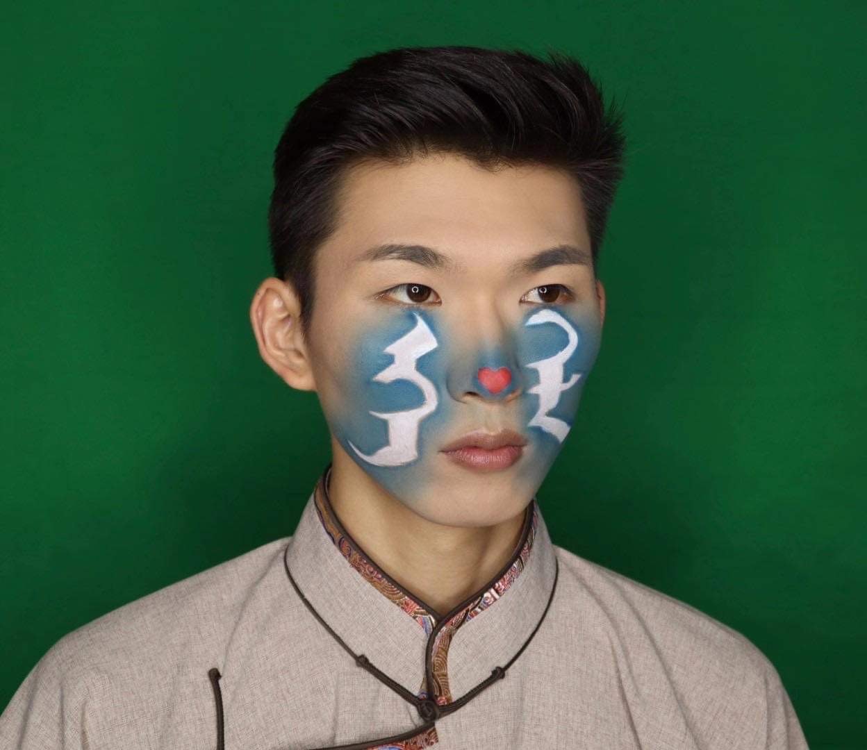 Mongolian words for Mother Tongue painted on a protester’s face